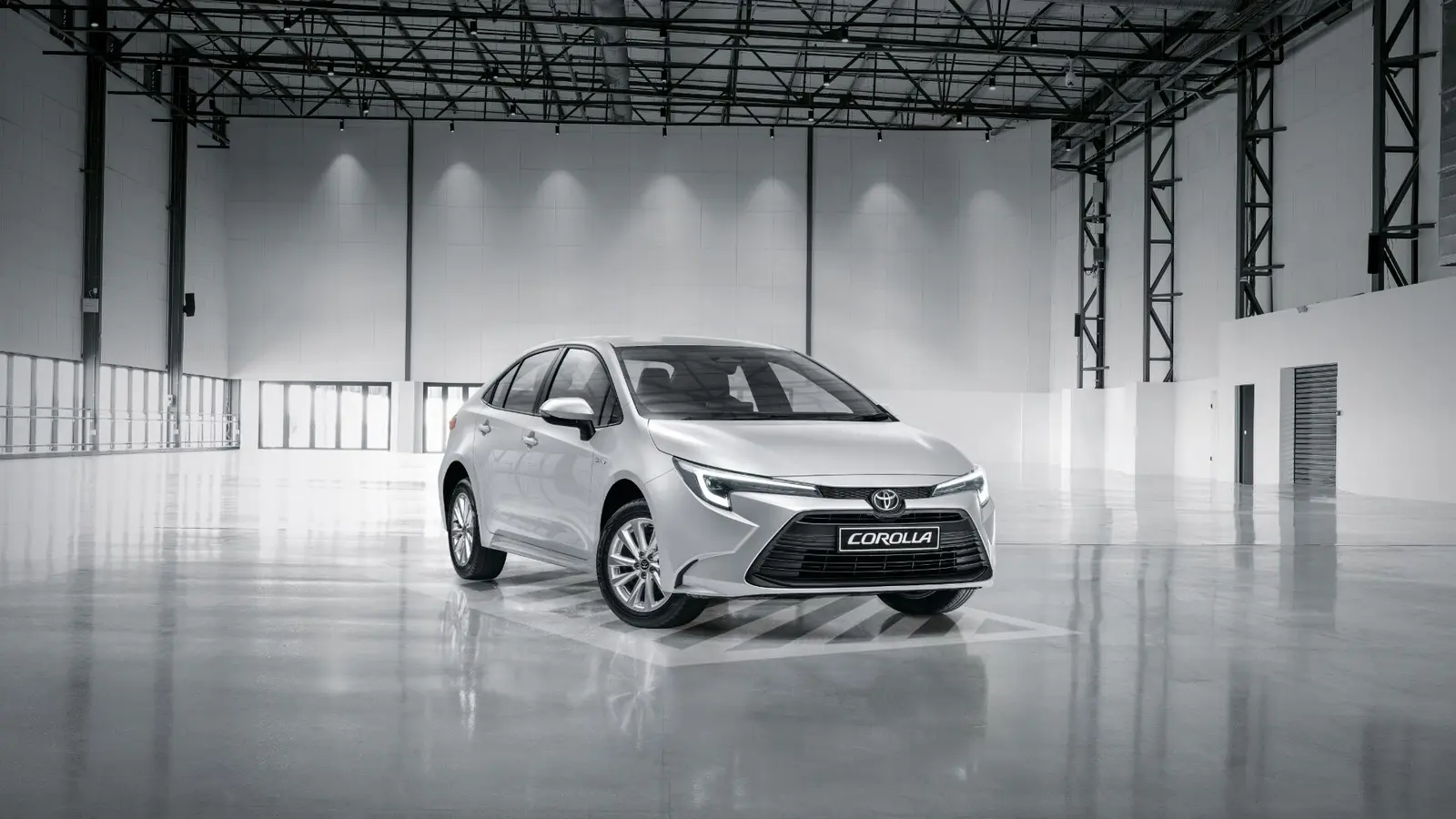 Silver Toyota Corolla sedan in a bright showroom